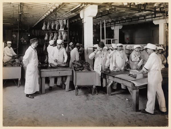 Men in white coats inspecting food products