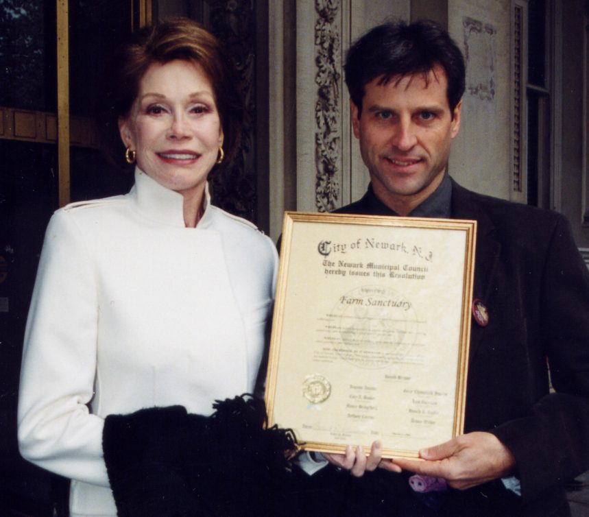 Mary Tyler Moore and Gene Baur hold a resolution from the City of Newark, NJ.